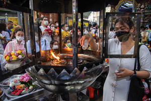 A Hindu devotee pours an oil to make merit during a ceremony to mark the Ganesh Chaturthi festival at Wat Khaek in Bangkok. The Ganesh Chaturthi is a Hindu festival to commemorate the birth of the Hindu god Lord Ganesha.