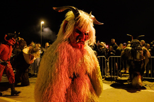 A Krampus walks by during a Krampus run. More than 600 Krampuses from Slovenia, Austria, Italy, and Croatia joined the tenth anniversary of the Krampus run in Goričane. Krampus, a horned demon-like figure, traditionally works alongside Saint Nicholas or Santa Claus. While Santa rewards good children with gifts, Krampus scares and gives birch rods to misbehaving children. The Krampus run aims to remind both children and adults who haven't been well-behaved to improve their behavior before Christmas.