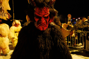 A Krampus poses for a photo during a Krampus run. More than 600 Krampuses from Slovenia, Austria, Italy, and Croatia joined the tenth anniversary of the Krampus run in Goričane. Krampus, a horned demon-like figure, traditionally works alongside Saint Nicholas or Santa Claus. While Santa rewards good children with gifts, Krampus scares and gives birch rods to misbehaving children. The Krampus run aims to remind both children and adults who haven't been well-behaved to improve their behavior before Christmas.