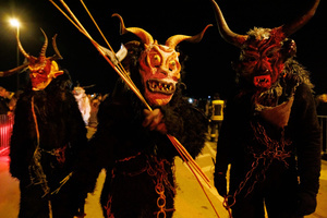 Krampusse pose for a photograph during a Krampus run. More than 600 Krampuses from Slovenia, Austria, Italy, and Croatia joined the tenth anniversary of the Krampus run in Goričane. Krampus, a horned demon-like figure, traditionally works alongside Saint Nicholas or Santa Claus. While Santa rewards good children with gifts, Krampus scares and gives birch rods to misbehaving children. The Krampus run aims to remind both children and adults who haven't been well-behaved to improve their behavior before Christmas.