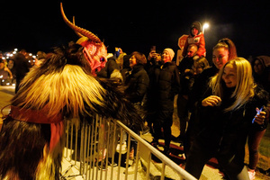 A Krampus scares the audience of the Krampus run. More than 600 Krampuses from Slovenia, Austria, Italy, and Croatia joined the tenth anniversary of the Krampus run in Goričane. Krampus, a horned demon-like figure, traditionally works alongside Saint Nicholas or Santa Claus. While Santa rewards good children with gifts, Krampus scares and gives birch rods to misbehaving children. The Krampus run aims to remind both children and adults who haven't been well-behaved to improve their behavior before Christmas.