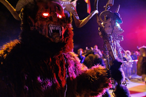 A Krampus walks by during a Krampus run. More than 600 Krampuses from Slovenia, Austria, Italy, and Croatia joined the tenth anniversary of the Krampus run in Goričane. Krampus, a horned demon-like figure, traditionally works alongside Saint Nicholas or Santa Claus. While Santa rewards good children with gifts, Krampus scares and gives birch rods to misbehaving children. The Krampus run aims to remind both children and adults who haven't been well-behaved to improve their behavior before Christmas.