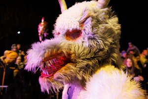 A Krampus walks by during a Krampus run. More than 600 Krampuses from Slovenia, Austria, Italy, and Croatia joined the tenth anniversary of the Krampus run in Goričane. Krampus, a horned demon-like figure, traditionally works alongside Saint Nicholas or Santa Claus. While Santa rewards good children with gifts, Krampus scares and gives birch rods to misbehaving children. The Krampus run aims to remind both children and adults who haven't been well-behaved to improve their behavior before Christmas.