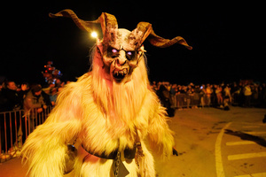 A Krampus poses for a photo during a Krampus run. More than 600 Krampuses from Slovenia, Austria, Italy, and Croatia joined the tenth anniversary of the Krampus run in Goričane. Krampus, a horned demon-like figure, traditionally works alongside Saint Nicholas or Santa Claus. While Santa rewards good children with gifts, Krampus scares and gives birch rods to misbehaving children. The Krampus run aims to remind both children and adults who haven't been well-behaved to improve their behavior before Christmas.