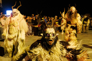 A Krampus poses for a photo during a Krampus run. More than 600 Krampuses from Slovenia, Austria, Italy, and Croatia joined the tenth anniversary of the Krampus run in Goričane. Krampus, a horned demon-like figure, traditionally works alongside Saint Nicholas or Santa Claus. While Santa rewards good children with gifts, Krampus scares and gives birch rods to misbehaving children. The Krampus run aims to remind both children and adults who haven't been well-behaved to improve their behavior before Christmas.