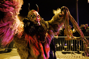 A Krampus performs during a Krampus run. More than 600 Krampuses from Slovenia, Austria, Italy, and Croatia joined the tenth anniversary of the Krampus run in Goričane. Krampus, a horned demon-like figure, traditionally works alongside Saint Nicholas or Santa Claus. While Santa rewards good children with gifts, Krampus scares and gives birch rods to misbehaving children. The Krampus run aims to remind both children and adults who haven't been well-behaved to improve their behavior before Christmas.