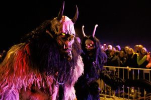 Krampusse walk by during a Krampus run. More than 600 Krampuses from Slovenia, Austria, Italy, and Croatia joined the tenth anniversary of the Krampus run in Goričane. Krampus, a horned demon-like figure, traditionally works alongside Saint Nicholas or Santa Claus. While Santa rewards good children with gifts, Krampus scares and gives birch rods to misbehaving children. The Krampus run aims to remind both children and adults who haven't been well-behaved to improve their behavior before Christmas.