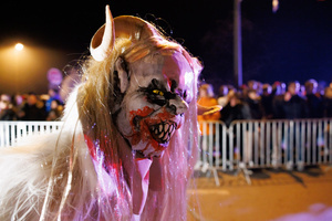 A Krampus walks by during a Krampus run. More than 600 Krampuses from Slovenia, Austria, Italy, and Croatia joined the tenth anniversary of the Krampus run in Goričane. Krampus, a horned demon-like figure, traditionally works alongside Saint Nicholas or Santa Claus. While Santa rewards good children with gifts, Krampus scares and gives birch rods to misbehaving children. The Krampus run aims to remind both children and adults who haven't been well-behaved to improve their behavior before Christmas.