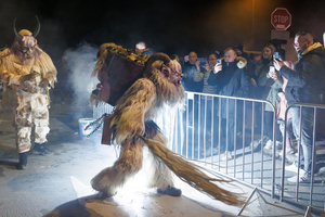 A Krampus scares the audience during a Krampus run. More than 600 Krampuses from Slovenia, Austria, Italy, and Croatia joined the tenth anniversary of the Krampus run in Goričane. Krampus, a horned demon-like figure, traditionally works alongside Saint Nicholas or Santa Claus. While Santa rewards good children with gifts, Krampus scares and gives birch rods to misbehaving children. The Krampus run aims to remind both children and adults who haven't been well-behaved to improve their behavior before Christmas.