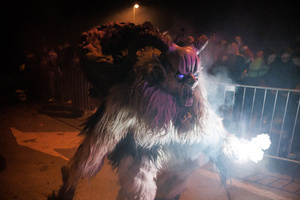 A Krampus walks by during a Krampus run. More than 600 Krampuses from Slovenia, Austria, Italy, and Croatia joined the tenth anniversary of the Krampus run in Goričane. Krampus, a horned demon-like figure, traditionally works alongside Saint Nicholas or Santa Claus. While Santa rewards good children with gifts, Krampus scares and gives birch rods to misbehaving children. The Krampus run aims to remind both children and adults who haven't been well-behaved to improve their behavior before Christmas.