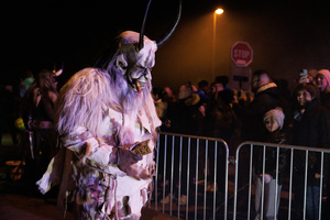 A Krampus walks by during a Krampus run. More than 600 Krampuses from Slovenia, Austria, Italy, and Croatia joined the tenth anniversary of the Krampus run in Goričane. Krampus, a horned demon-like figure, traditionally works alongside Saint Nicholas or Santa Claus. While Santa rewards good children with gifts, Krampus scares and gives birch rods to misbehaving children. The Krampus run aims to remind both children and adults who haven't been well-behaved to improve their behavior before Christmas.
