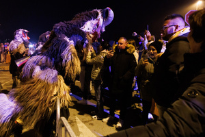 A Krampus scares the audience during a Krampus run. More than 600 Krampuses from Slovenia, Austria, Italy, and Croatia joined the tenth anniversary of the Krampus run in Goričane. Krampus, a horned demon-like figure, traditionally works alongside Saint Nicholas or Santa Claus. While Santa rewards good children with gifts, Krampus scares and gives birch rods to misbehaving children. The Krampus run aims to remind both children and adults who haven't been well-behaved to improve their behavior before Christmas.