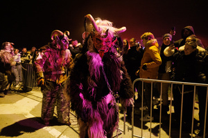 A Krampus walks by during a Krampus run. More than 600 Krampuses from Slovenia, Austria, Italy, and Croatia joined the tenth anniversary of the Krampus run in Goričane. Krampus, a horned demon-like figure, traditionally works alongside Saint Nicholas or Santa Claus. While Santa rewards good children with gifts, Krampus scares and gives birch rods to misbehaving children. The Krampus run aims to remind both children and adults who haven't been well-behaved to improve their behavior before Christmas.