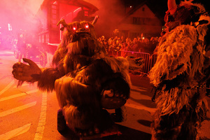 Krampusse walk by during a Krampus run. More than 600 Krampuses from Slovenia, Austria, Italy, and Croatia joined the tenth anniversary of the Krampus run in Goričane. Krampus, a horned demon-like figure, traditionally works alongside Saint Nicholas or Santa Claus. While Santa rewards good children with gifts, Krampus scares and gives birch rods to misbehaving children. The Krampus run aims to remind both children and adults who haven't been well-behaved to improve their behavior before Christmas.