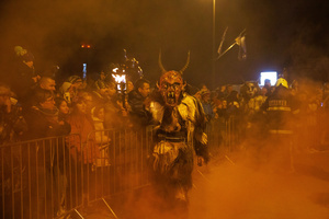 A Krampus poses for a photo during a Krampus run. More than 600 Krampuses from Slovenia, Austria, Italy, and Croatia joined the tenth anniversary of the Krampus run in Goričane. Krampus, a horned demon-like figure, traditionally works alongside Saint Nicholas or Santa Claus. While Santa rewards good children with gifts, Krampus scares and gives birch rods to misbehaving children. The Krampus run aims to remind both children and adults who haven't been well-behaved to improve their behavior before Christmas.