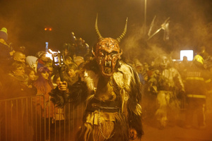 A Krampus poses for a photo during a Krampus run. More than 600 Krampuses from Slovenia, Austria, Italy, and Croatia joined the tenth anniversary of the Krampus run in Goričane. Krampus, a horned demon-like figure, traditionally works alongside Saint Nicholas or Santa Claus. While Santa rewards good children with gifts, Krampus scares and gives birch rods to misbehaving children. The Krampus run aims to remind both children and adults who haven't been well-behaved to improve their behavior before Christmas.