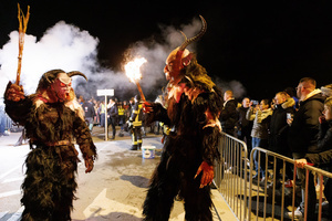 Krampusse walk by during a Krampus run. More than 600 Krampuses from Slovenia, Austria, Italy, and Croatia joined the tenth anniversary of the Krampus run in Goričane. Krampus, a horned demon-like figure, traditionally works alongside Saint Nicholas or Santa Claus. While Santa rewards good children with gifts, Krampus scares and gives birch rods to misbehaving children. The Krampus run aims to remind both children and adults who haven't been well-behaved to improve their behavior before Christmas.