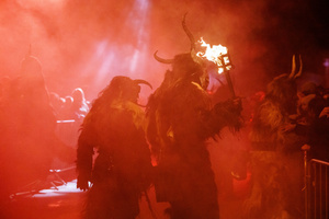 Krampusse walk by during a Krampus run. More than 600 Krampuses from Slovenia, Austria, Italy, and Croatia joined the tenth anniversary of the Krampus run in Goričane. Krampus, a horned demon-like figure, traditionally works alongside Saint Nicholas or Santa Claus. While Santa rewards good children with gifts, Krampus scares and gives birch rods to misbehaving children. The Krampus run aims to remind both children and adults who haven't been well-behaved to improve their behavior before Christmas.