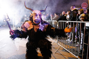 A Krampus poses for a photograph during a Krampus run. More than 600 Krampuses from Slovenia, Austria, Italy, and Croatia joined the tenth anniversary of the Krampus run in Goričane. Krampus, a horned demon-like figure, traditionally works alongside Saint Nicholas or Santa Claus. While Santa rewards good children with gifts, Krampus scares and gives birch rods to misbehaving children. The Krampus run aims to remind both children and adults who haven't been well-behaved to improve their behavior before Christmas.