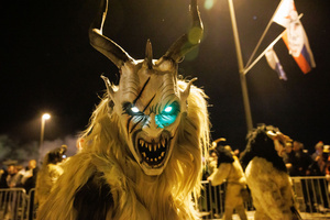 A Krampus walks by during a Krampus run. More than 600 Krampuses from Slovenia, Austria, Italy, and Croatia joined the tenth anniversary of the Krampus run in Goričane. Krampus, a horned demon-like figure, traditionally works alongside Saint Nicholas or Santa Claus. While Santa rewards good children with gifts, Krampus scares and gives birch rods to misbehaving children. The Krampus run aims to remind both children and adults who haven't been well-behaved to improve their behavior before Christmas.