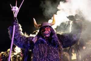 A Krampus poses for a photo during a Krampus run. More than 600 Krampuses from Slovenia, Austria, Italy, and Croatia joined the tenth anniversary of the Krampus run in Goričane. Krampus, a horned demon-like figure, traditionally works alongside Saint Nicholas or Santa Claus. While Santa rewards good children with gifts, Krampus scares and gives birch rods to misbehaving children. The Krampus run aims to remind both children and adults who haven't been well-behaved to improve their behavior before Christmas.