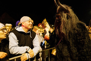 A Krampus shows the audience a severed animal leg during a Krampus run. More than 600 Krampuses from Slovenia, Austria, Italy, and Croatia joined the tenth anniversary of the Krampus run in Goričane. Krampus, a horned demon-like figure, traditionally works alongside Saint Nicholas or Santa Claus. While Santa rewards good children with gifts, Krampus scares and gives birch rods to misbehaving children. The Krampus run aims to remind both children and adults who haven't been well-behaved to improve their behavior before Christmas.