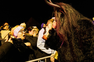A Krampus scares the audience with a severed animal leg during a Krampus run. More than 600 Krampuses from Slovenia, Austria, Italy, and Croatia joined the tenth anniversary of the Krampus run in Goričane. Krampus, a horned demon-like figure, traditionally works alongside Saint Nicholas or Santa Claus. While Santa rewards good children with gifts, Krampus scares and gives birch rods to misbehaving children. The Krampus run aims to remind both children and adults who haven't been well-behaved to improve their behavior before Christmas.
