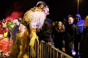 A Krampus scares the audience during a Krampus run. More than 600 Krampuses from Slovenia, Austria, Italy, and Croatia joined the tenth anniversary of the Krampus run in Goričane. Krampus, a horned demon-like figure, traditionally works alongside Saint Nicholas or Santa Claus. While Santa rewards good children with gifts, Krampus scares and gives birch rods to misbehaving children. The Krampus run aims to remind both children and adults who haven't been well-behaved to improve their behavior before Christmas.