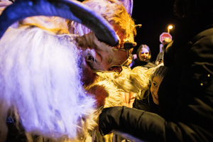 A Krampus interracts with the audience during a Krampus run. More than 600 Krampuses from Slovenia, Austria, Italy, and Croatia joined the tenth anniversary of the Krampus run in Goričane. Krampus, a horned demon-like figure, traditionally works alongside Saint Nicholas or Santa Claus. While Santa rewards good children with gifts, Krampus scares and gives birch rods to misbehaving children. The Krampus run aims to remind both children and adults who haven't been well-behaved to improve their behavior before Christmas.