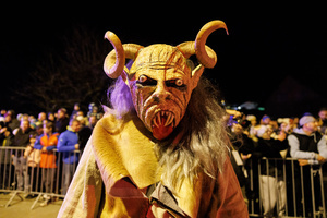 A Krampus poses for a photo during a Krampus run. More than 600 Krampuses from Slovenia, Austria, Italy, and Croatia joined the tenth anniversary of the Krampus run in Goričane. Krampus, a horned demon-like figure, traditionally works alongside Saint Nicholas or Santa Claus. While Santa rewards good children with gifts, Krampus scares and gives birch rods to misbehaving children. The Krampus run aims to remind both children and adults who haven't been well-behaved to improve their behavior before Christmas.