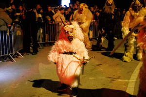 A child dressed in a Krampus costume walks by during a Krampus run. More than 600 Krampuses from Slovenia, Austria, Italy, and Croatia joined the tenth anniversary of the Krampus run in Goričane. Krampus, a horned demon-like figure, traditionally works alongside Saint Nicholas or Santa Claus. While Santa rewards good children with gifts, Krampus scares and gives birch rods to misbehaving children. The Krampus run aims to remind both children and adults who haven't been well-behaved to improve their behavior before Christmas.