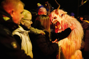 A Krampus scares the audience during a Krampus run. More than 600 Krampuses from Slovenia, Austria, Italy, and Croatia joined the tenth anniversary of the Krampus run in Goričane. Krampus, a horned demon-like figure, traditionally works alongside Saint Nicholas or Santa Claus. While Santa rewards good children with gifts, Krampus scares and gives birch rods to misbehaving children. The Krampus run aims to remind both children and adults who haven't been well-behaved to improve their behavior before Christmas.