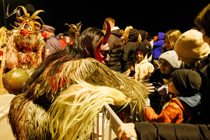 A Krampus scares the audience during a Krampus run. More than 600 Krampuses from Slovenia, Austria, Italy, and Croatia joined the tenth anniversary of the Krampus run in Goričane. Krampus, a horned demon-like figure, traditionally works alongside Saint Nicholas or Santa Claus. While Santa rewards good children with gifts, Krampus scares and gives birch rods to misbehaving children. The Krampus run aims to remind both children and adults who haven't been well-behaved to improve their behavior before Christmas.