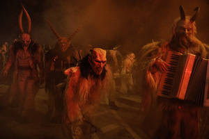 Krampusse walk by during a Krampus run. More than 600 Krampuses from Slovenia, Austria, Italy, and Croatia joined the tenth anniversary of the Krampus run in Goričane. Krampus, a horned demon-like figure, traditionally works alongside Saint Nicholas or Santa Claus. While Santa rewards good children with gifts, Krampus scares and gives birch rods to misbehaving children. The Krampus run aims to remind both children and adults who haven't been well-behaved to improve their behavior before Christmas.