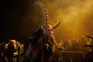 A Krampus walks by during a Krampus run. More than 600 Krampuses from Slovenia, Austria, Italy, and Croatia joined the tenth anniversary of the Krampus run in Goričane. Krampus, a horned demon-like figure, traditionally works alongside Saint Nicholas or Santa Claus. While Santa rewards good children with gifts, Krampus scares and gives birch rods to misbehaving children. The Krampus run aims to remind both children and adults who haven't been well-behaved to improve their behavior before Christmas.