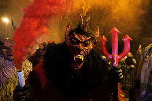 A Krampus poses for a photo during a Krampus run. More than 600 Krampuses from Slovenia, Austria, Italy, and Croatia joined the tenth anniversary of the Krampus run in Goričane. Krampus, a horned demon-like figure, traditionally works alongside Saint Nicholas or Santa Claus. While Santa rewards good children with gifts, Krampus scares and gives birch rods to misbehaving children. The Krampus run aims to remind both children and adults who haven't been well-behaved to improve their behavior before Christmas.