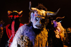 A Krampus poses for a photo during a Krampus run. More than 600 Krampuses from Slovenia, Austria, Italy, and Croatia joined the tenth anniversary of the Krampus run in Goričane. Krampus, a horned demon-like figure, traditionally works alongside Saint Nicholas or Santa Claus. While Santa rewards good children with gifts, Krampus scares and gives birch rods to misbehaving children. The Krampus run aims to remind both children and adults who haven't been well-behaved to improve their behavior before Christmas.