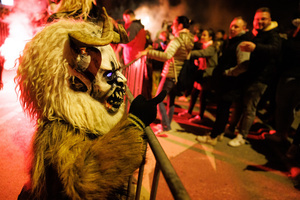 A Krampus taunts the audience during a Krampus run. More than 600 Krampuses from Slovenia, Austria, Italy, and Croatia joined the tenth anniversary of the Krampus run in Goričane. Krampus, a horned demon-like figure, traditionally works alongside Saint Nicholas or Santa Claus. While Santa rewards good children with gifts, Krampus scares and gives birch rods to misbehaving children. The Krampus run aims to remind both children and adults who haven't been well-behaved to improve their behavior before Christmas.