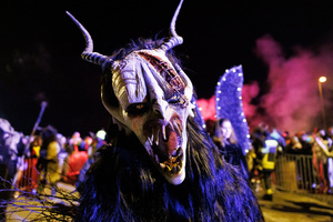 A Krampus poses for a photo during a Krampus run. More than 600 Krampuses from Slovenia, Austria, Italy, and Croatia joined the tenth anniversary of the Krampus run in Goričane. Krampus, a horned demon-like figure, traditionally works alongside Saint Nicholas or Santa Claus. While Santa rewards good children with gifts, Krampus scares and gives birch rods to misbehaving children. The Krampus run aims to remind both children and adults who haven't been well-behaved to improve their behavior before Christmas.