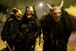 Krampusse pose for a photo during a Krampus run. More than 600 Krampuses from Slovenia, Austria, Italy, and Croatia joined the tenth anniversary of the Krampus run in Goričane. Krampus, a horned demon-like figure, traditionally works alongside Saint Nicholas or Santa Claus. While Santa rewards good children with gifts, Krampus scares and gives birch rods to misbehaving children. The Krampus run aims to remind both children and adults who haven't been well-behaved to improve their behavior before Christmas.