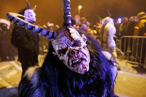 A Krampus poses for a photo during a Krampus run. More than 600 Krampuses from Slovenia, Austria, Italy, and Croatia joined the tenth anniversary of the Krampus run in Goričane. Krampus, a horned demon-like figure, traditionally works alongside Saint Nicholas or Santa Claus. While Santa rewards good children with gifts, Krampus scares and gives birch rods to misbehaving children. The Krampus run aims to remind both children and adults who haven't been well-behaved to improve their behavior before Christmas.