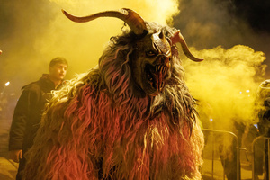 A Krampus walks by during a Krampus run. More than 600 Krampuses from Slovenia, Austria, Italy, and Croatia joined the tenth anniversary of the Krampus run in Goričane. Krampus, a horned demon-like figure, traditionally works alongside Saint Nicholas or Santa Claus. While Santa rewards good children with gifts, Krampus scares and gives birch rods to misbehaving children. The Krampus run aims to remind both children and adults who haven't been well-behaved to improve their behavior before Christmas.