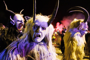 Krampusse walk by during a Krampus run. More than 600 Krampuses from Slovenia, Austria, Italy, and Croatia joined the tenth anniversary of the Krampus run in Goričane. Krampus, a horned demon-like figure, traditionally works alongside Saint Nicholas or Santa Claus. While Santa rewards good children with gifts, Krampus scares and gives birch rods to misbehaving children. The Krampus run aims to remind both children and adults who haven't been well-behaved to improve their behavior before Christmas.