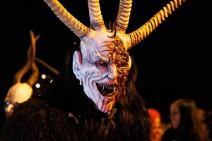 A Krampus walks by during a Krampus run. More than 600 Krampuses from Slovenia, Austria, Italy, and Croatia joined the tenth anniversary of the Krampus run in Goričane. Krampus, a horned demon-like figure, traditionally works alongside Saint Nicholas or Santa Claus. While Santa rewards good children with gifts, Krampus scares and gives birch rods to misbehaving children. The Krampus run aims to remind both children and adults who haven't been well-behaved to improve their behavior before Christmas.
