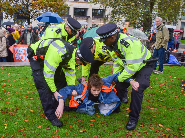 Police officers arrest a Just Stop Oil activist outside Shell headquarters as the climate action group continue their protests against new fossil fuel licences.