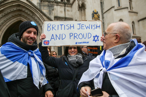 A protester holds a placard during the demonstration. Over 100,000 demonstrators took part in a march against antisemitism. The march was organized by the charity Campaign Against Antisemitism.