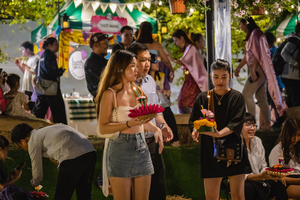 A family is seen carrying krathongs during the Magical Loy Krathong Festival at Jodd Fairs Dan Neramit in Bangkok. Loy Krathong, Thailand's Festival of Lights, is celebrated annually across Thailand and nearby regions. During this festival, people float decorated baskets made of banana leaves, incense sticks, and candles on rivers, canals, or ponds. They make wishes as they release these floating offerings.