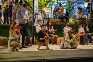 Thai and foreigners are seen with their krathong, on the bank of the lake, during the Magical Loy Krathong Festival at Jodd Fairs Dan Neramit in Bangkok. Loy Krathong, Thailand's Festival of Lights, is celebrated annually across Thailand and nearby regions. During this festival, people float decorated baskets made of banana leaves, incense sticks, and candles on rivers, canals, or ponds. They make wishes as they release these baskets.