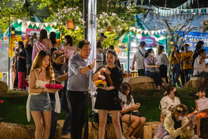A family is seen lighting their krathong on the lake during the Magical Loy Krathong Festival at Jodd Fairs Dan Neramit in Bangkok. Loy Krathong, Thailand's Festival of Lights, is celebrated annually across Thailand and nearby regions. During this festival, people float decorated baskets made of banana leaves, incense sticks, and candles on rivers, canals, or ponds. They make wishes as they release these baskets.