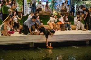 A woman is seen placing her krathong on the lake during the Magical Loy Krathong Festival at Jodd Fairs Dan Neramit in Bangkok. Loy Krathong, Thailand's Festival of Lights, is celebrated annually across Thailand and nearby regions. During this festival, people float decorated baskets made of banana leaves, incense sticks, and candles on rivers, canals, or ponds. They make wishes as they release these floating offerings.